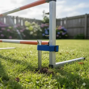 Close-up of metal ground stakes securing a dog agility jump to prevent tipping during use.