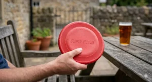A flexible rubber dog frisbee being held, demonstrating the soft material safe for gums.