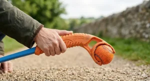 Demonstrating the hands-free pickup feature of the Chuckit! ball launcher.