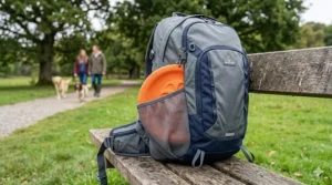 An illustration of a floating frisbee for dogs tucked into a side pocket of a standard dog walking rucksack.