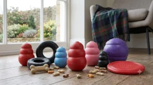 A photorealistic, high-detail photograph capturing a diverse collection of various genuine Kong dog toys on oak floorboards, including Classic reds, puppy blues, senior pinks, tires, and a flyer.