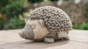 A plush toy made from recycled plastic bottles with stitched details