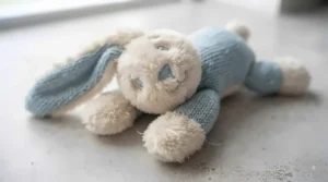 Soft plush puppy teething toy with a gentle squeaker suitable for sensitive young chewers.