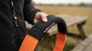 Trainer holding a professional dog tug toy with a comfortable padded handle for secure grip.
